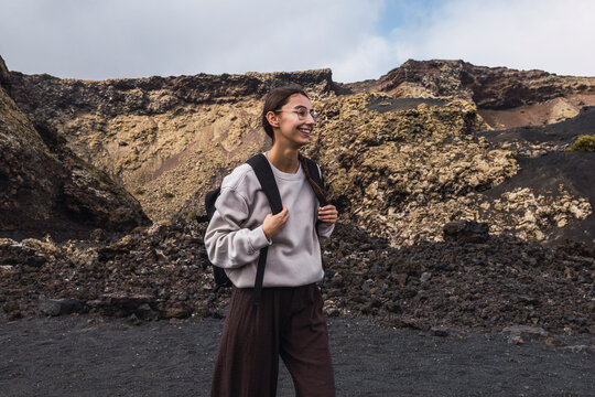 Young woman exploring volcanic landscape in Lanzarote