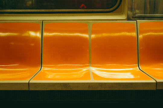 Empty orange seat on New York City subway in manhattan