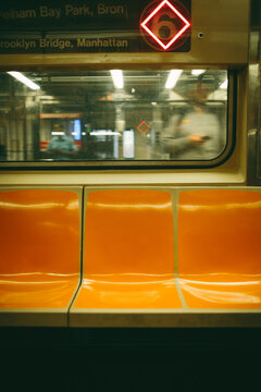 Empty orange seat on New York subway train in Manhattan