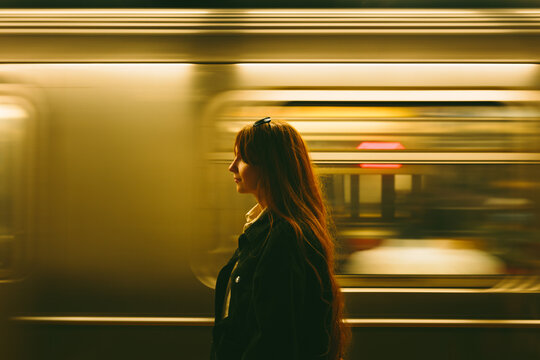 Woman waiting on Manhattan subway platform in New York