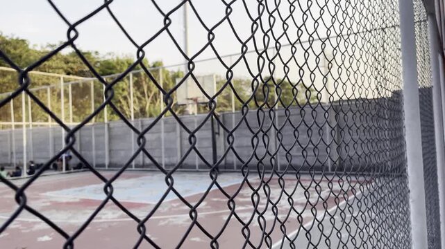 Chain link fence around outdoor sports court concept
