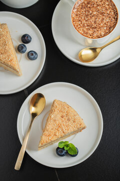 Medovik. Honey cake made from honey cakes with whipped sour cream, decorated with berries, pomegranate and flowers