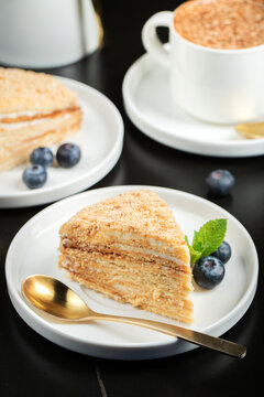 Medovik. Honey cake made from honey cakes with whipped sour cream, decorated with berries, pomegranate and flowers