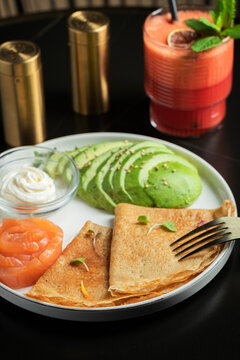 Roasted thin pancakes with smoked salmon and sauce