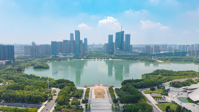 Panoramic cityscape of modern waterfront business district with lake reflecting skyscrapers
