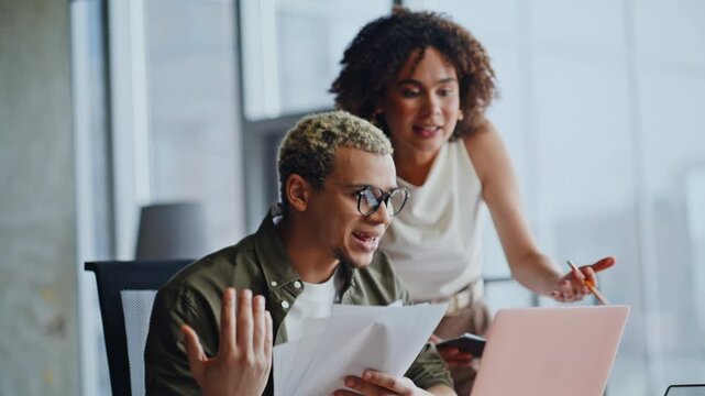 Shocked business man woman reacting bad news on laptop in office, work problem