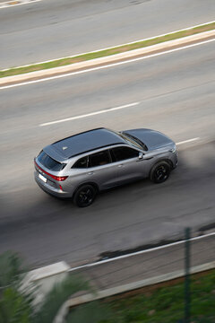 Grey BYD Song Plus rear three quarters moving, Plug in hybrid SUV driving on highway