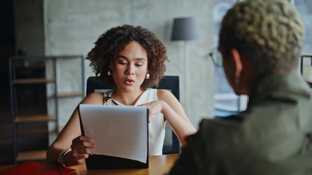 Confused businesswoman discussing documents with client. Closeup office meeting