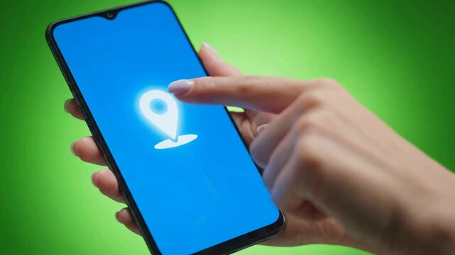 Hand holding smartphone with interactive gps map location pin on screen mobile