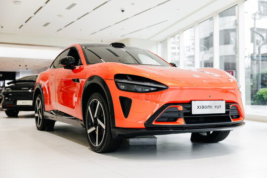 Guangzhou, China - December 22, 2025: Orange electric crossover xiaomi car YU7 vehicle in showroom