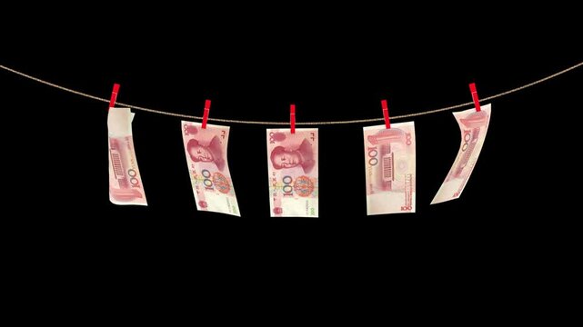 Chinese 100 yuan banknotes hanging on a rope swaying in the wind