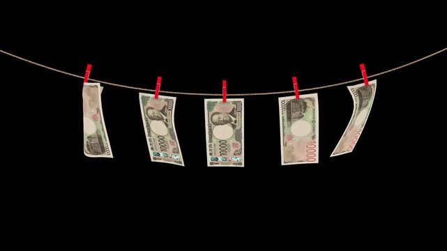 Japanese 10000 yen banknotes hanging on a rope swaying in the wind