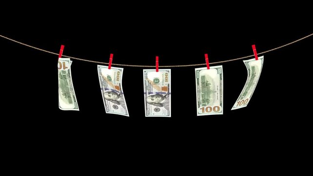 100 us dollar banknotes hanging on a rope swaying in the wind