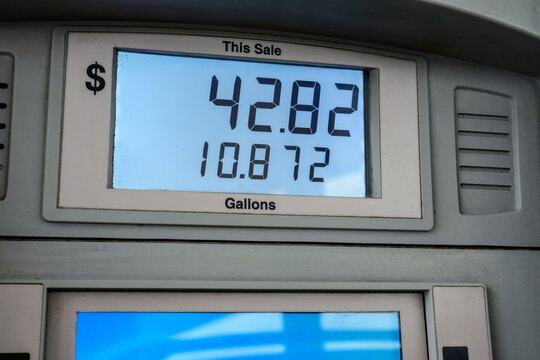 Close-up of a digital gas pump display showing a total sale with gallons pumped at a fueling station, illustrating fuel consumption costs.