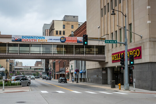Duluth, MN, USA - Jul 25, 2026: Downtown Duluth skywalk over Superior Street with the Wells Fargo branch building in the foreground.
