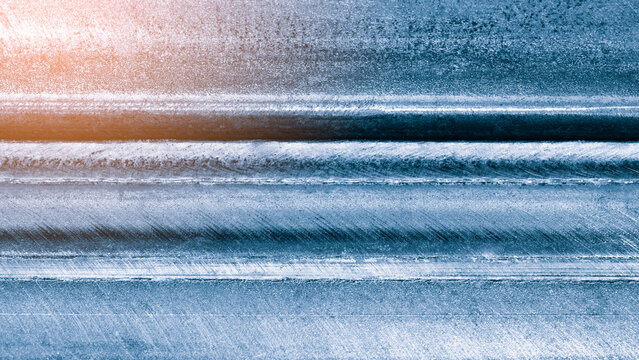 Welded horizontal metal welding seam as an industrial textured background. Abstract background fits digital interfaces or modern design projects