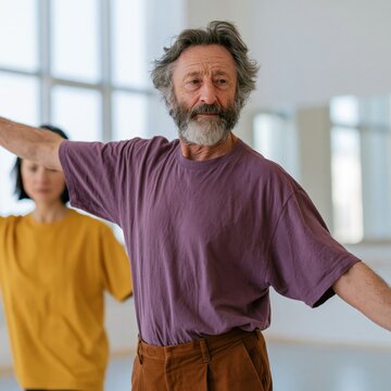 Bearded senior man practicing balance and movement in dance studio for class poster and wellness background