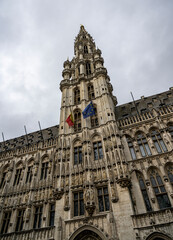 Obraz premium Town Hall tower with Belgian and EU flags at Grand Place, Brussels, Belgium