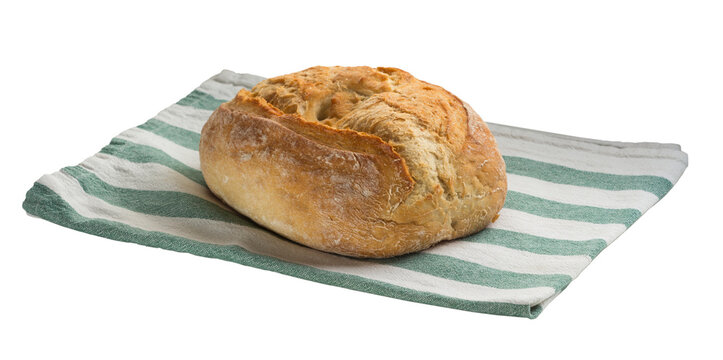 Homemade crusty wheat bread loaf on linen kitchen towel isolated on transparent background