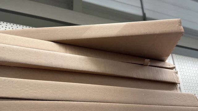 Neatly organized cardboard cartons are presented for sale in a store, providing reliable packaging options for online orders, warehouse storage, business supplies and household use. Close up.