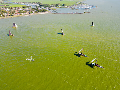 STAVOREN, THE NETHERLANDS AUGUST 12, 2023: Traditional Skutsjes Compete During the Annual SKS Skutsjesilen Sailing Championship on the IJsselmeer