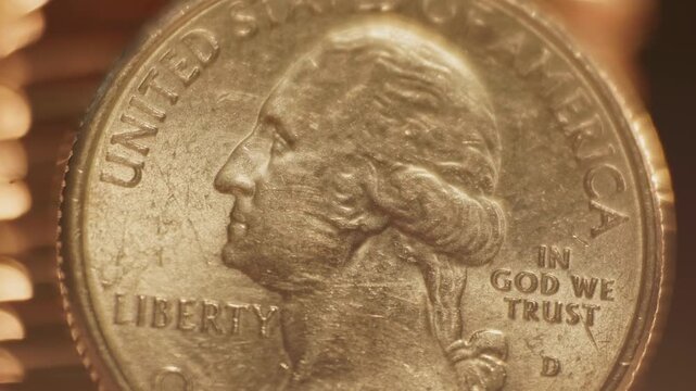 Close-up detailed macro view of George Washington on United States of America 25 cents coin worth one quarter of a dollar and quoting liberty and In God We Trust on money surface and U.S. currency 4k