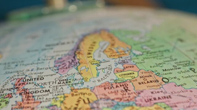 Slow motion close-up view of Earth globe macro of European countries on continent of Europe showing cities, country landmarks, water ways, and important places across western global map texture 4k