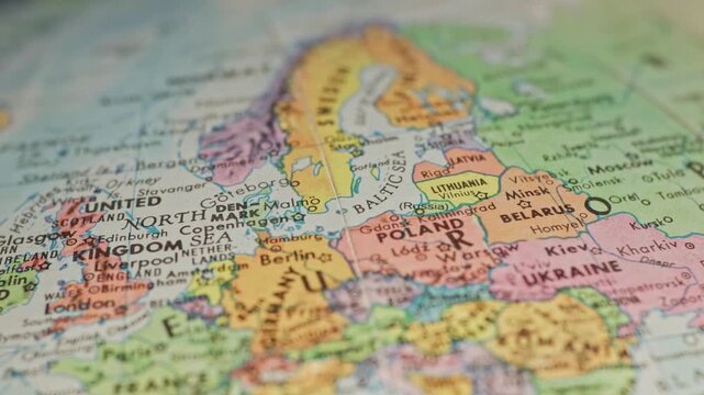 Slow motion close-up view of Earth globe macro of European countries on continent of Europe showing cities, country landmarks, water ways, and important places across western global map texture 4k