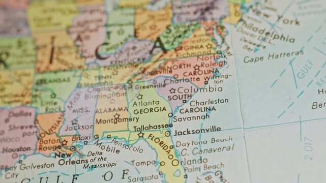 Slow motion macro close up view panning across United States of America map on spherical global chart of globe viewing individual states, cities, rivers, oceans, and locations on North American Earth