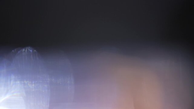 Real anamorphic lens flare light leak moving across the frame