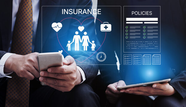 Business professionals discussing insurance options with digital interfaces showing policies and family health icons in a modern office environment. Bitwise.