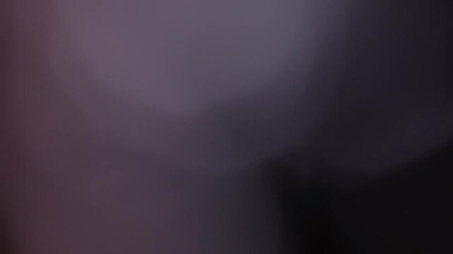 Blurred abstract white and purple geometric shapes.