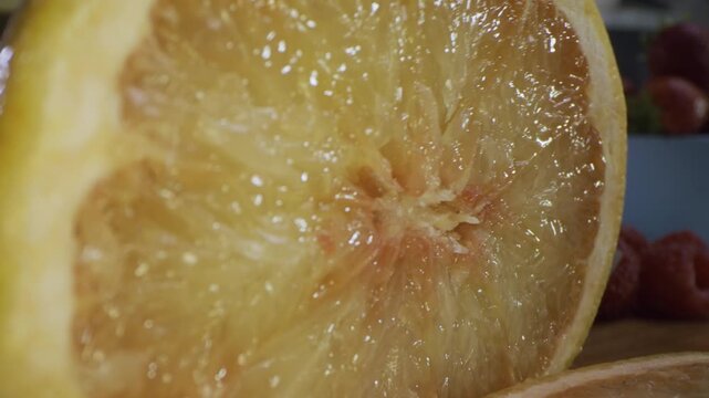 Knife cutting through juicy grapefruit, extra closeup shot