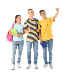 Obraz premium Happy students with backpacks and notebooks taking selfie on white background