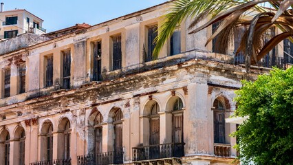 Naklejka premium Vathy, Greece - July 25, 2026: View of a house in Vathy on Samos Island, Greece, showing local residential architecture, simple facade, windows, and peaceful Greek island town atmosphere.
