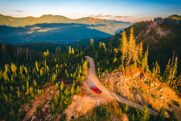 Red pickup truck on mountain road above Kachess Lake near Snoqualmie Pass, Washington © Victoria Nefedova