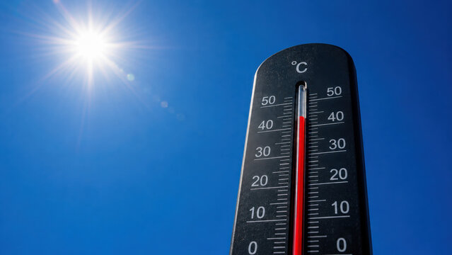 Hot weather, global climate change concept - Heat wave / Summer heat temperature celsius background banner long - Thermometer blue sky and sun rays