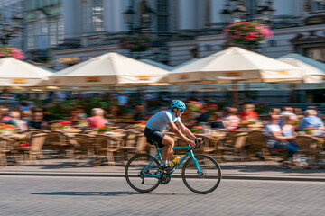 Naklejka premium Street cyclist speeding past summer cafe terraces