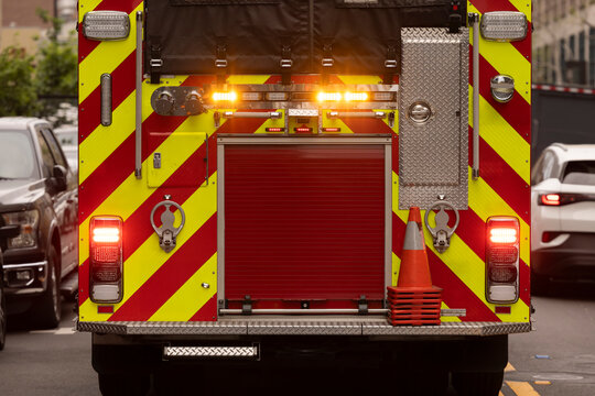 A fire engine responds to the scene of an emergency on a city street.
