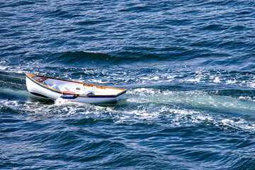 Fototapeta premium White Rowboat Floating on Blue Ocean Waves Near Gulf Islands Off Vancouver Island, BC, Canada
