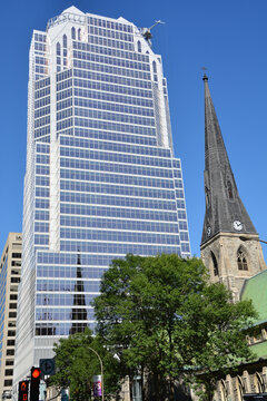 MONTREAL QUEBEC CANADA: Montreal Anglican Christ Church Cathedral in front the Tour KPMG or Place de la Cathedrale, is a 34 storey skyscraper located in Montreal that was completed in 1987.