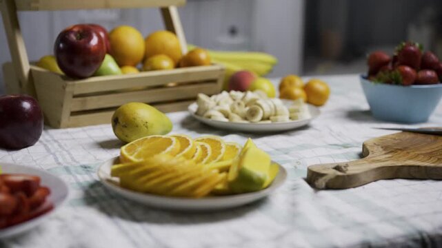 Counter filled with various fruits and a knife for cutting them - tracking shot