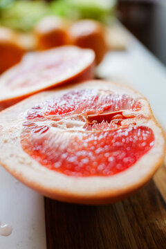 Juicy grapefruit cut open revealing vibrant flesh in a bright kitchen