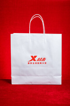 ZHONGSHAN China-February 12 2026: Xtep white branded paper shopping gift bag.