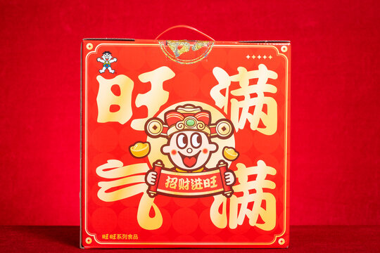 ZHONGSHAN China-February 12 2026: A festive red WantWant snack gift box printed with cartoon boy God of Wealth.