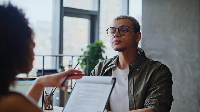 African american man discussing documents office meeting. Job interview talk.