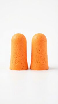Pair of orange foam earplugs for noise protection with earplugs protection suppression auditory