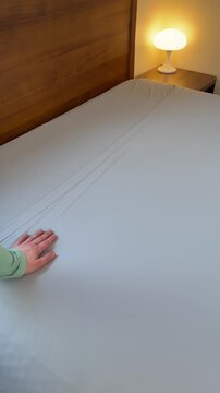 running hands over the top of a clean sheet