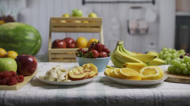 Kitchen counter filled with lots of delicious fruit on plates - wide, tracking shot