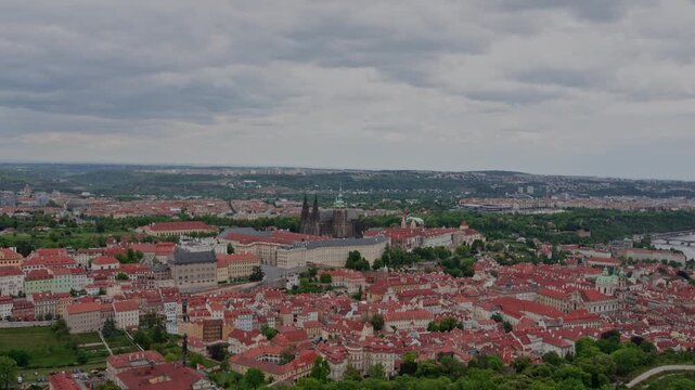 Panoramic drone view of the historic Prague Castle and St. Vitus Cathedral over the Lesser Town (Mal&aacute; Strana) on a cloudy day.